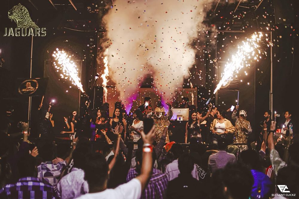 Nightclub crowd enjoying live DJ music