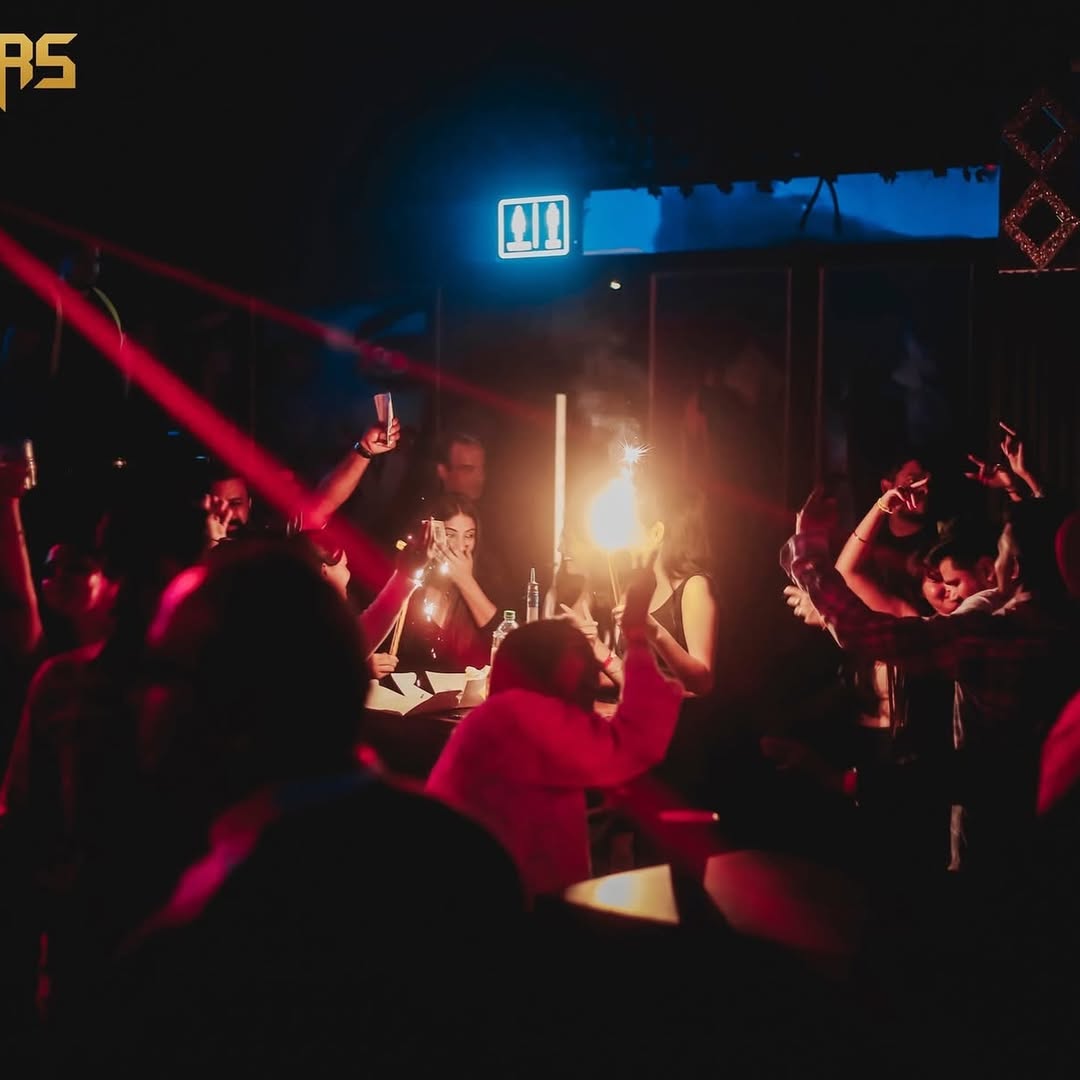 Crowd enjoying popular DJ sets at best night club